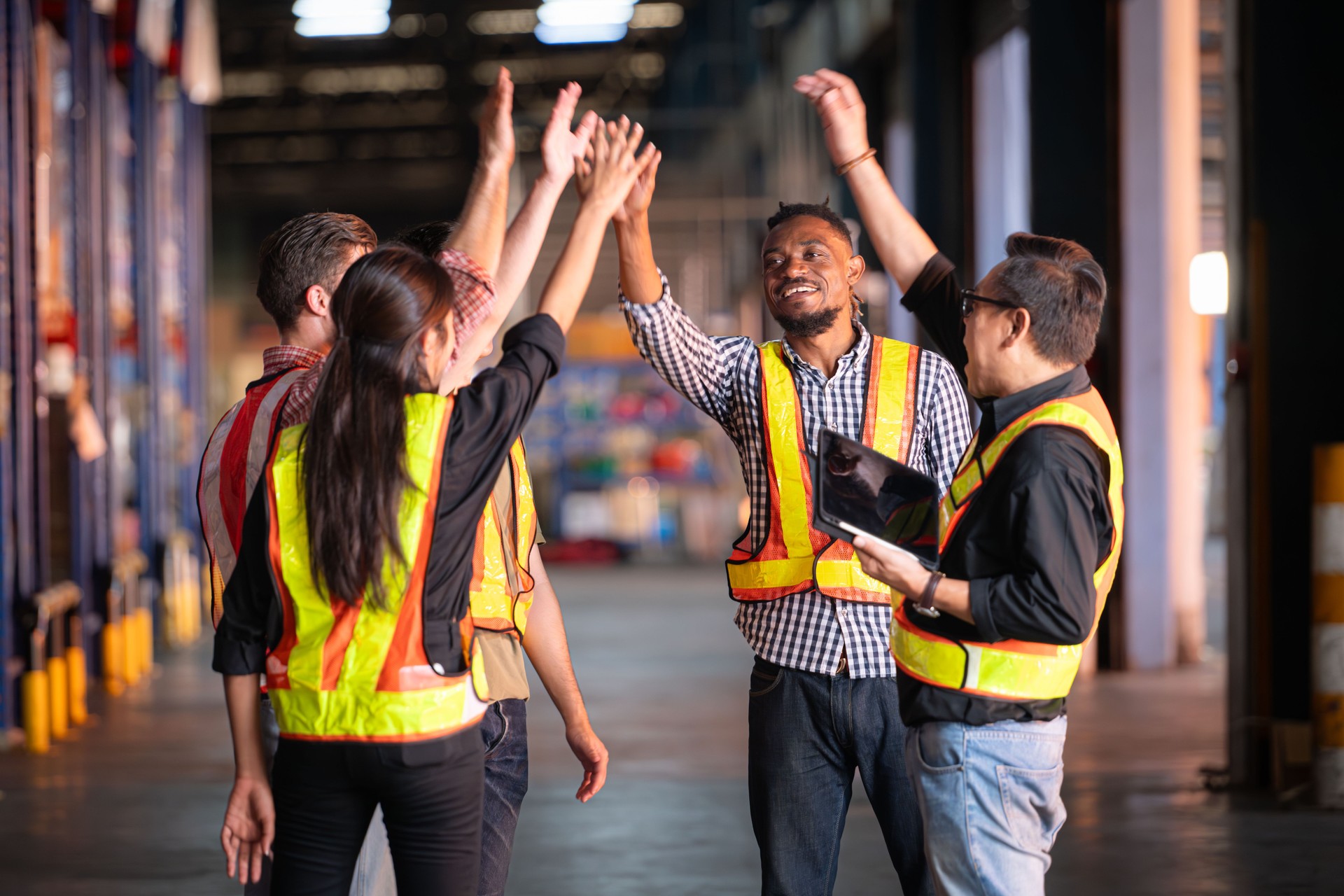 A group of warehouse employees, Inspecting products on warehouse shelves before they are sent to retailer